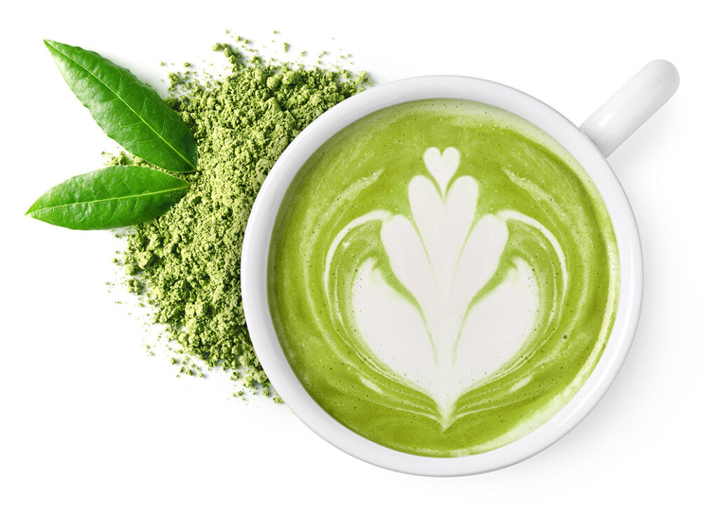 a cup of match latte with powdered leaves